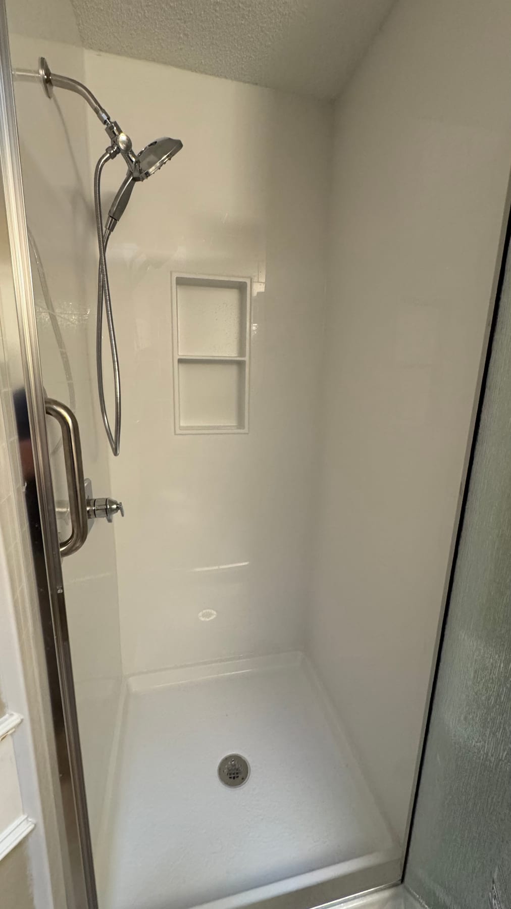 Bright white accessible shower with glass enclosure