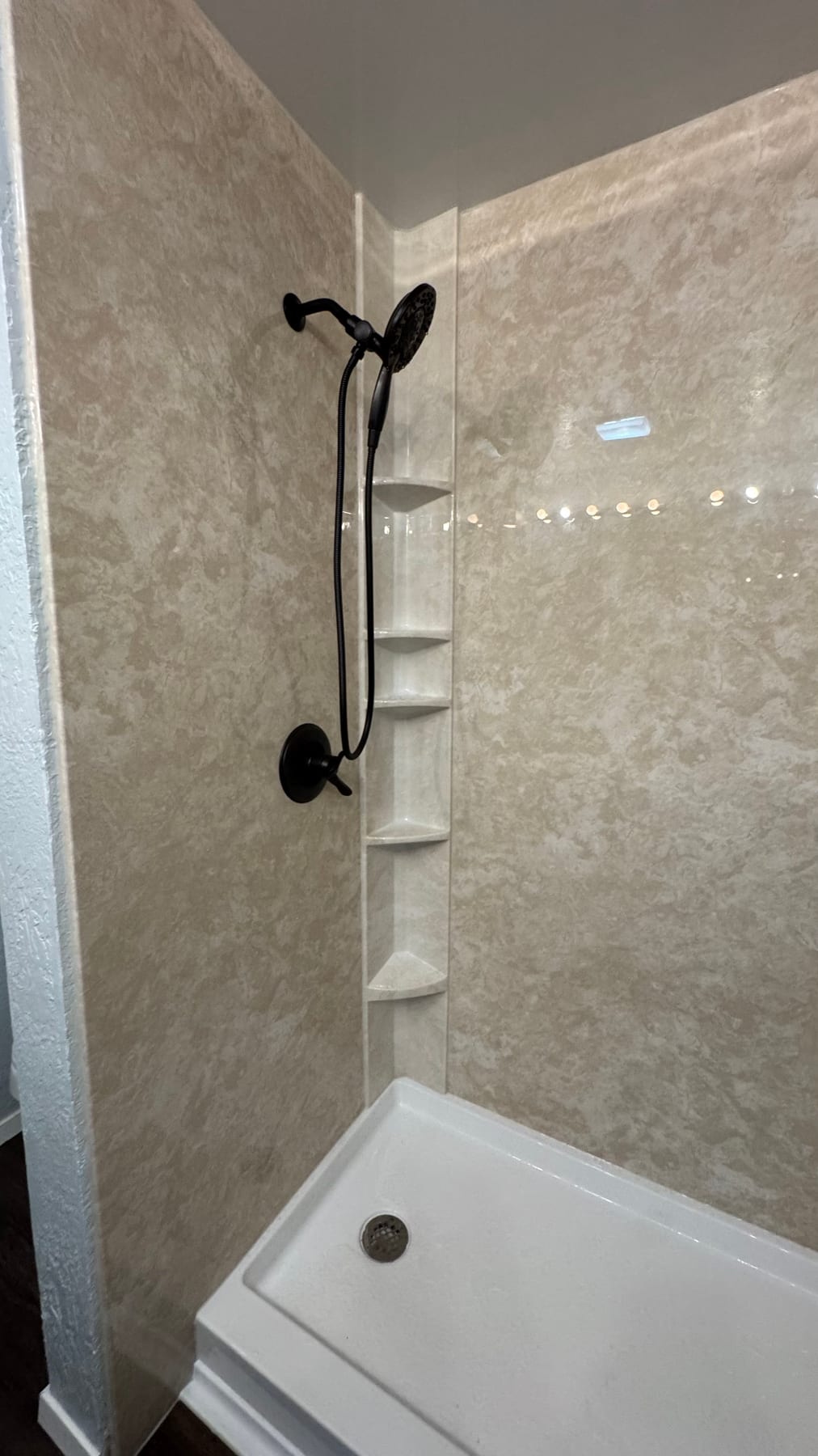 Gray stone-look shower with matte-black fixtures